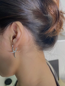 925 sterling silver starfish hoop earring with polished finish shown on model