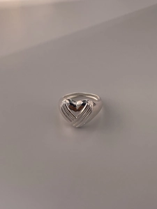 Detailed view of 925 sterling silver heart ring with sunburst engraved textures