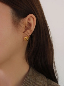 Minimalist 925 sterling silver knotted earrings with polished gold finish on model