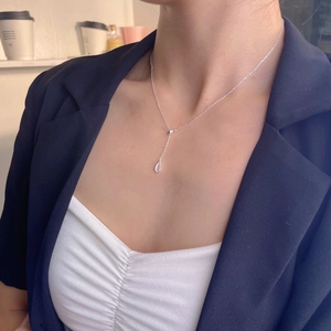 Elegant 925 sterling silver water drop necklace worn with a navy blazer and white top