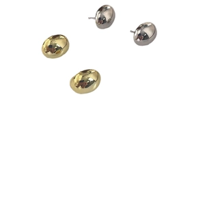 Polished 925 sterling silver and gold bean stud earrings on white background