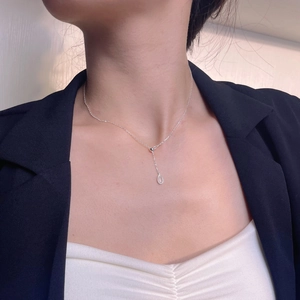 Minimalist 925 sterling silver waterdrop necklace on model in elegant business attire