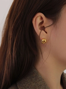 Classic golden knot stud earrings shown on model for an elegant vintage style