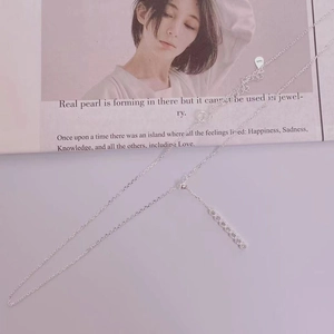 Close-up of S925 sterling silver necklace with minimalist vertical row of zircons