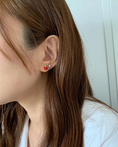 Red apple and white pearl stud earring set in 925 silver shown on a female model
