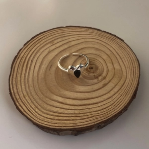 Close-up of S925 sterling silver stamp on an adjustable ring with a black heart stone