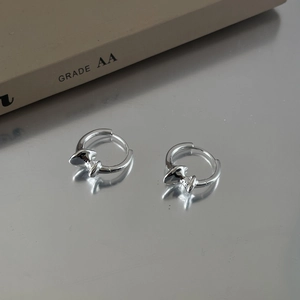 Detail view of S925 sterling silver bow knot earrings with high-polish mirror finish