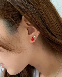 925 silver stud earrings with cute red apple and tiny pearl shown on a female ear