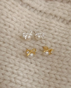 Close-up of S925 silver bow stud earrings with sparkling zircon and elegant pearls