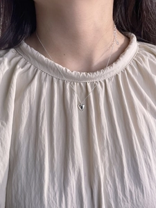 Delicate 925 sterling silver necklace with heart black agate pendant on model neck