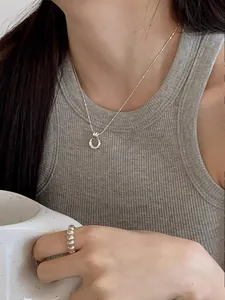 Close-up of S925 sterling silver double ring necklace and beaded ring on female model
