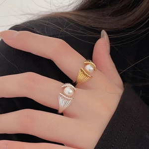 Macro shot of S925 sterling silver shell rings with elegant white pearls on model