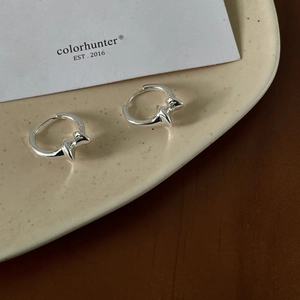 Detail view of S925 sterling silver stamp on minimalist irregular hoop earrings