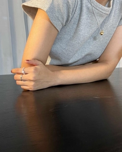 925 silver beaded necklace and minimalist rings worn by a model in a cozy lifestyle setting