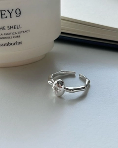 Macro detail of silver adjustable ring featuring starburst engraving and organic lines