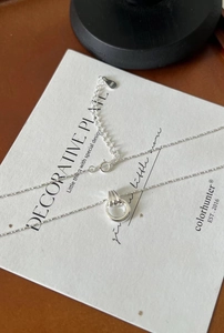 Detail shot of S925 sterling silver chain with hallmark stamp and minimalist pendant