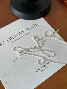 Macro shot of S925 sterling silver平安扣 necklace on a designer card background