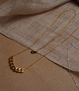 Collana minimalista in argento S925 dorato con maglie spesse su sfondo di lino materico