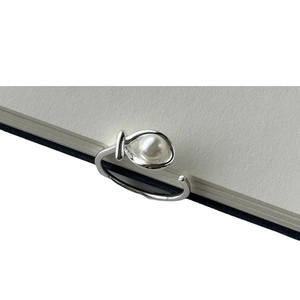 Minimalist 925 sterling silver open ring with a round white pearl on a clean paper background