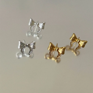 Elegant textured bow knot stud earrings in gold and silver finishes for women