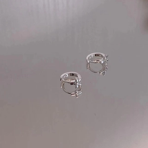 Detailed close-up of 925 sterling silver hoop earrings with delicate star cross design