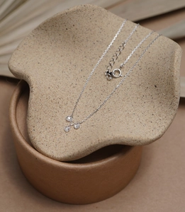 Detailed view of 925 silver necklace with three round faceted zircon pendants and spring clasp