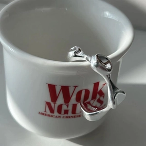 Irregular liquid style S925 sterling silver open ring on white ceramic cup edge