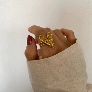 Model wearing 18K gold sterling silver heart ring with irregular lava texture