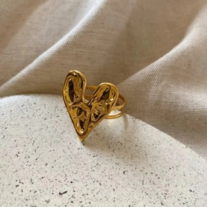 Macro shot of 18K gold plated silver heart ring with hammered texture and double bands