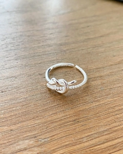 Detail showing S925 sterling silver hallmark and knot texture on adjustable ring