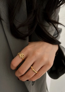 Detailed view of layered 925 silver golden bow and bamboo texture open rings on hand