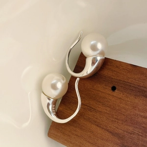 Macro shot of S925 sterling silver stamp on minimalist pearl drop earring hook