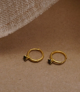 Detailed close-up of 925 silver hoop earrings with black zircon in a six-prong crown setting