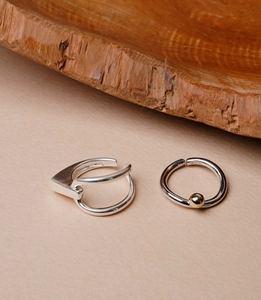 Close-up of S925 sterling silver geometric ear cuff and ring with gold bead detail