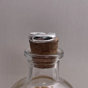 Detail of S925 sterling silver ring with beaded edge on cork top in macro view