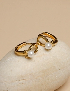 Detail of 925 sterling silver gold-plated pearl hoop earrings with S925 engraving