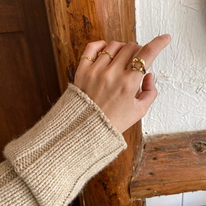 Three-piece gold geometric ring set with chain and wavy designs for minimalist styling