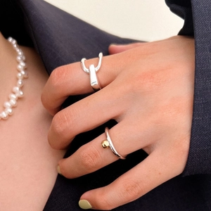 Minimalist 925 sterling silver geometric rings with gold bead detail on model