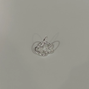 Macro detail of silver layered irregular hollow flower ring with polished finish
