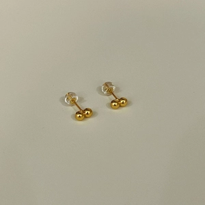 Detailed view of 925 sterling silver golden bean earrings with silicone backings
