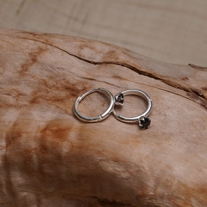Minimalist 925 sterling silver hoop earrings with black star zircon charms on wood