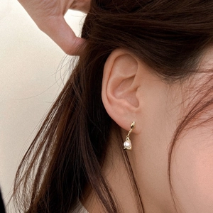 Elegant 925 silver pearl drop earring in gold finish worn by a model for a luxury look
