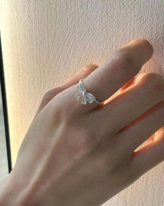 Close-up of elegant S925 sterling silver bowknot ring with central cubic zirconia stone