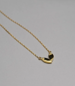 Detail of 925 sterling silver minimalist golden V-shaped double leaf pendant necklace