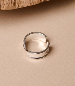 Macro shot of minimalist S925 sterling silver ring with dual-layer overlapping design