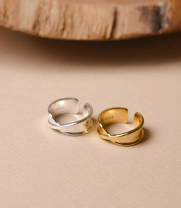Close-up of S925 sterling silver stamp on minimalist twisted gold and silver rings