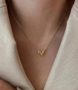 Close-up of a minimalist gold-plated 925 silver heart necklace on a model's neck
