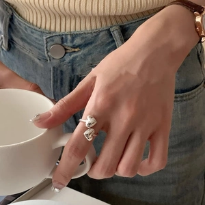 925 sterling silver open ring featuring double heart design worn in a casual setting
