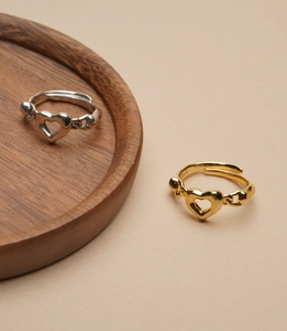 Detail of S925 sterling silver adjustable rings with hollow heart and chain design