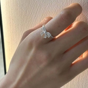 Elegant 925 sterling silver bow knot ring with hollow design and shimmering zircons for women